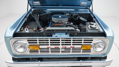 1973 Ford Bronco in Brittany Blue over Whiskey leather engine angle front
