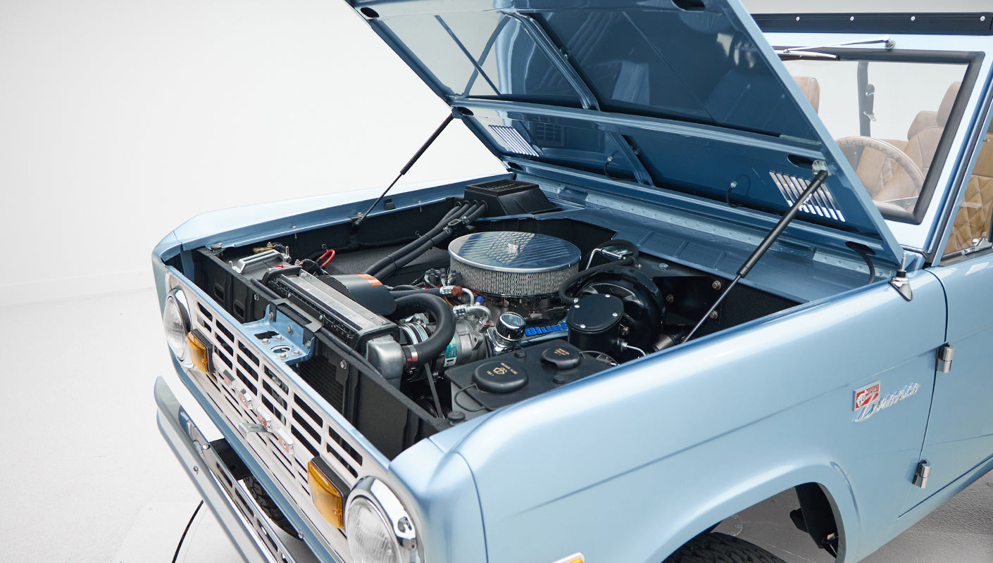 1973 Ford Bronco in Brittany Blue over Whiskey leather engine angle