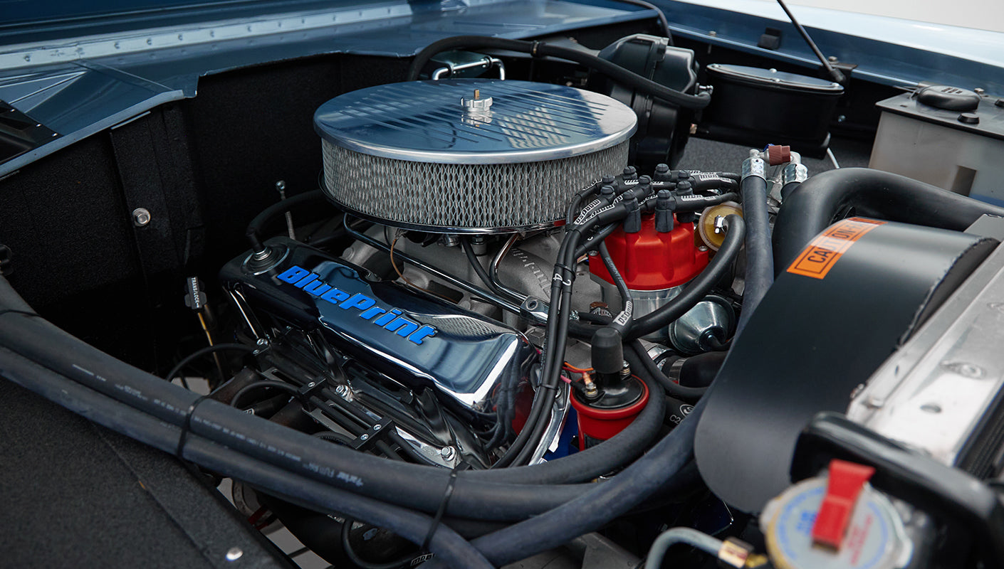 1973 Ford Bronco in Brittany Blue over Whiskey leather engine detail