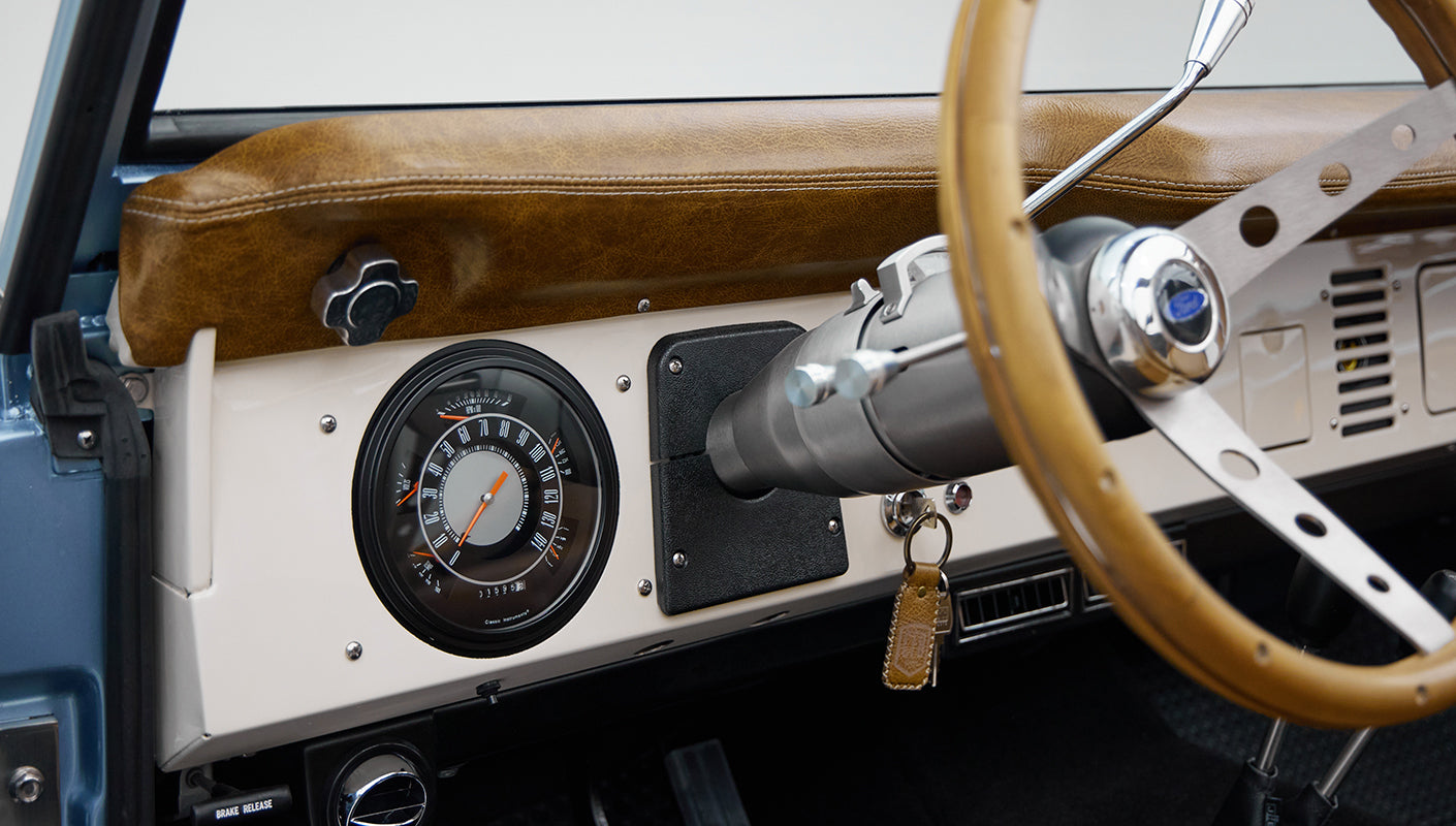1973 Ford Bronco in Brittany Blue over Whiskey leather driver dash
