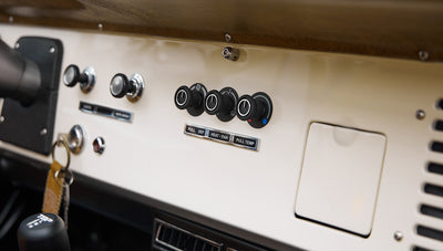 1973 Ford Bronco in Brittany Blue over Whiskey leather climate knobs