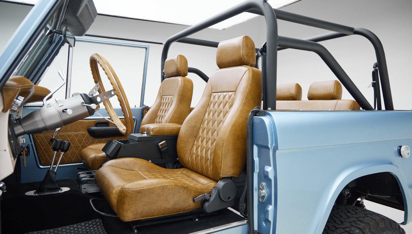 1973 Ford Bronco in Brittany Blue over Whiskey leather driver seat