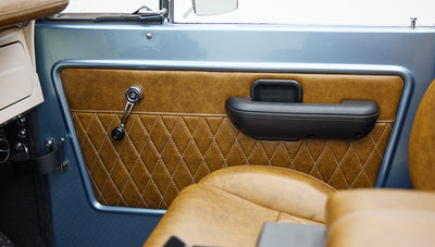 1973 Ford Bronco in Brittany Blue over Whiskey leather door panel detail