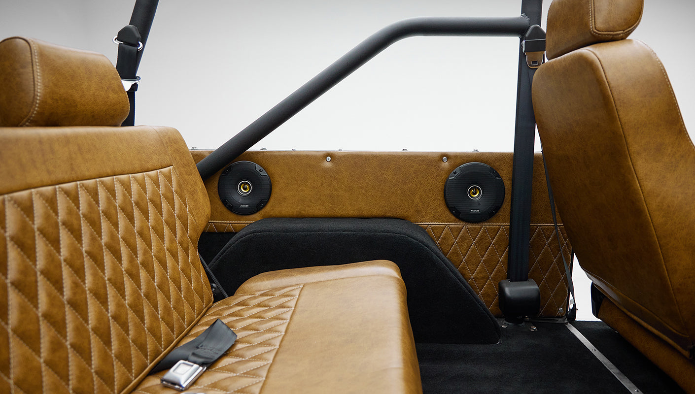 1973 Ford Bronco in Brittany Blue over Whiskey leather rear speaker panel