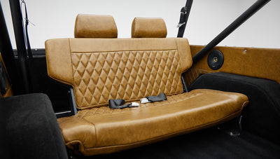 1973 Ford Bronco in Brittany Blue over Whiskey leather rear seat