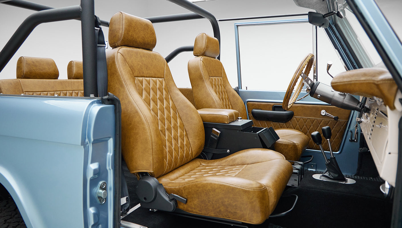 1973 Ford Bronco in Brittany Blue over Whiskey leather passenger seat angle