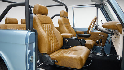 1973 Ford Bronco in Brittany Blue over Whiskey leather passenger seat angle
