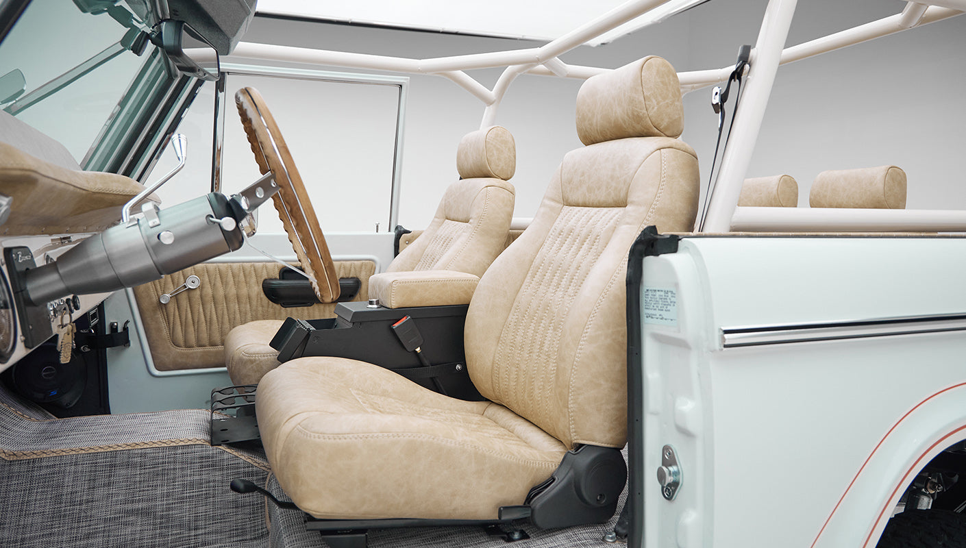 1973 classic ford bronco in diamond blue with butterscotch leather interior, vintage decals and chrome trim driver seat