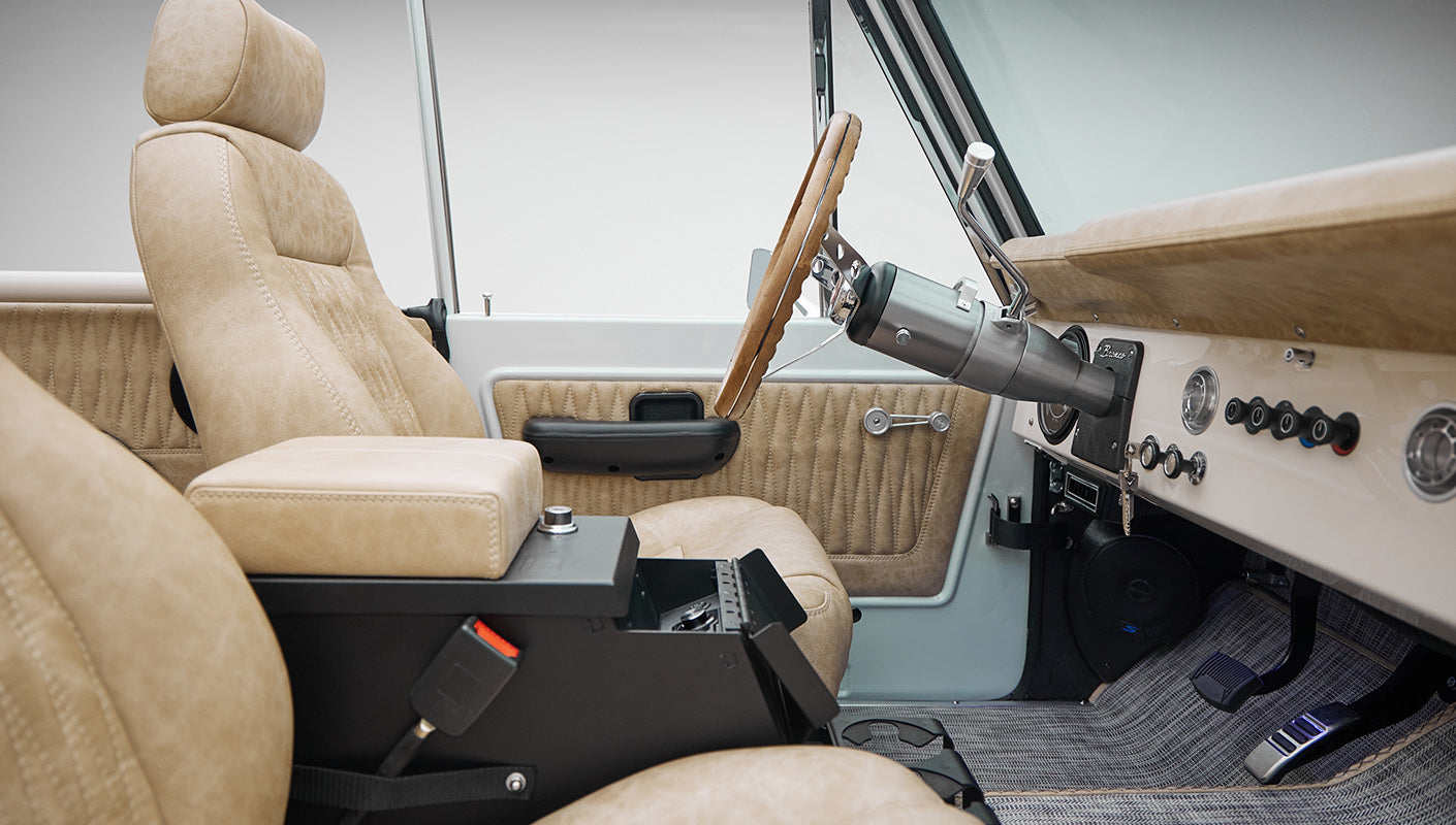 1973 classic ford bronco in diamond blue with butterscotch leather interior, vintage decals and chrome trim interior detail