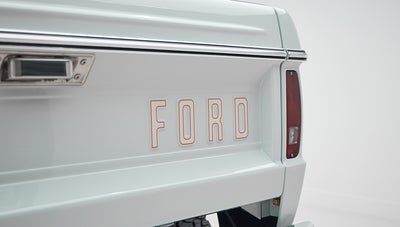 1973 classic ford bronco in diamond blue with butterscotch leather interior, vintage decals and chrome trim emblem
