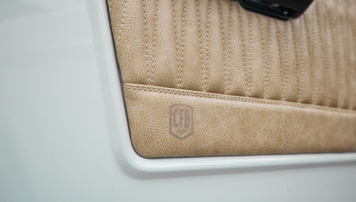 1973 classic ford bronco in diamond blue with butterscotch leather interior, vintage decals and chrome trim door panel