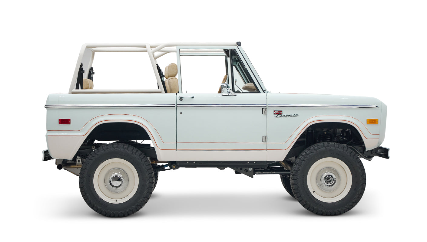 1973 classic ford bronco in diamond blue with butterscotch leather interior, vintage decals and chrome trim passenger profile