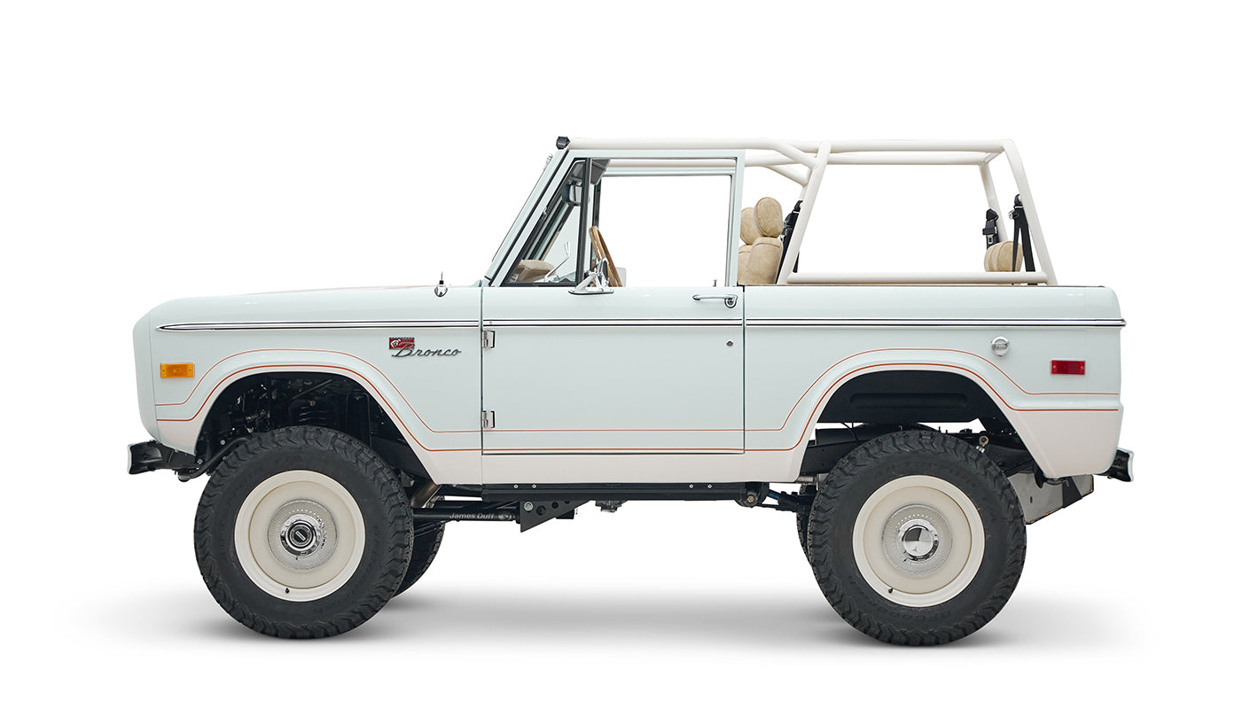 1973 classic ford bronco in diamond blue with butterscotch leather interior, vintage decals and chrome trim driver profile