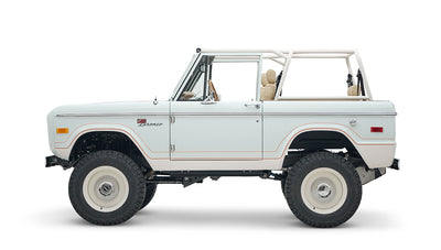 1973 classic ford bronco in diamond blue with butterscotch leather interior, vintage decals and chrome trim driver profile