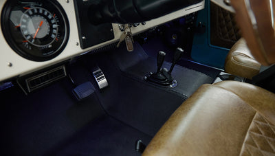 Close-up of Classic Ford Bronco driver's footwell with pedals and gear shift levers