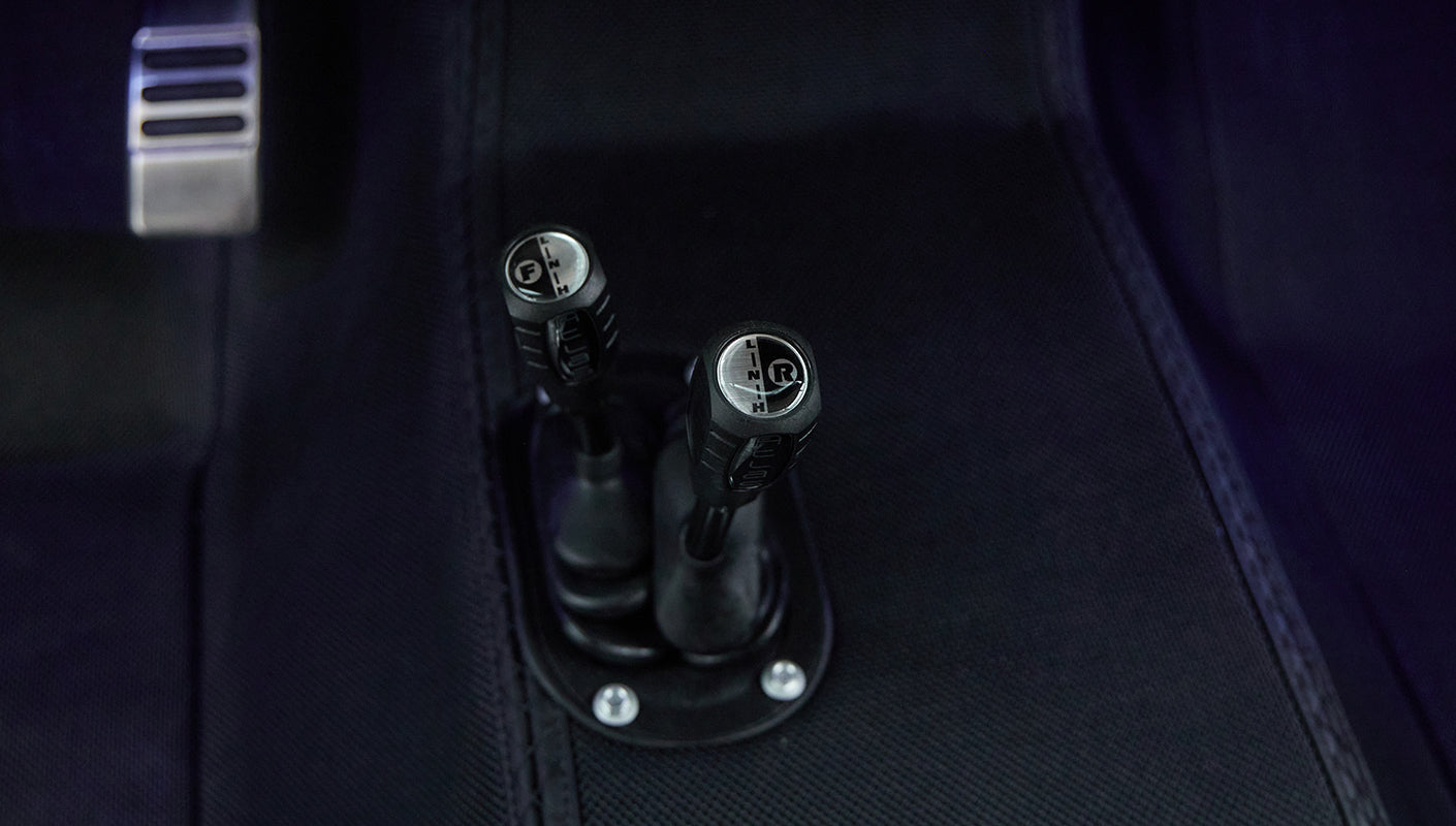 Two gear shift levers in Classic Ford Bronco interior with gear markings visible