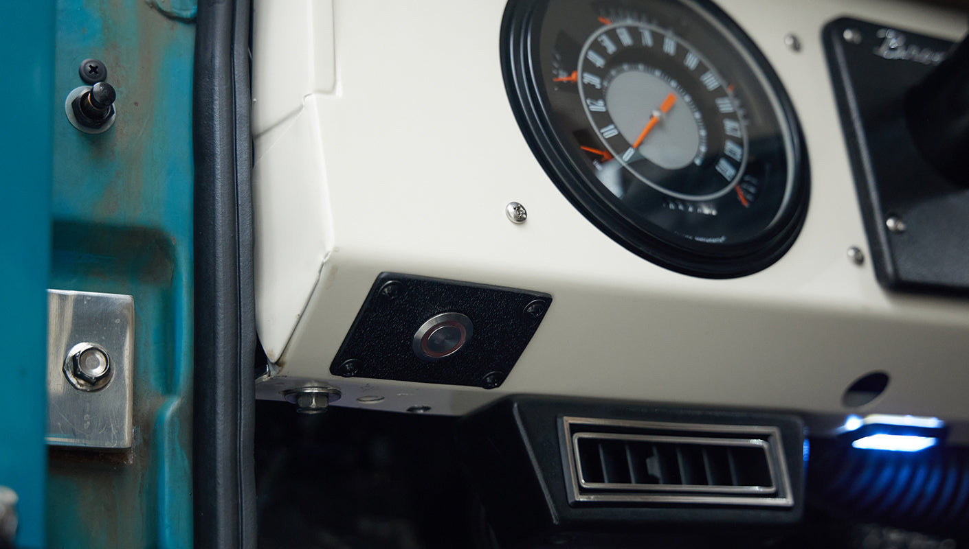Instrument panel with round gauge and vent in turquoise and white interior of Classic Ford Bronco