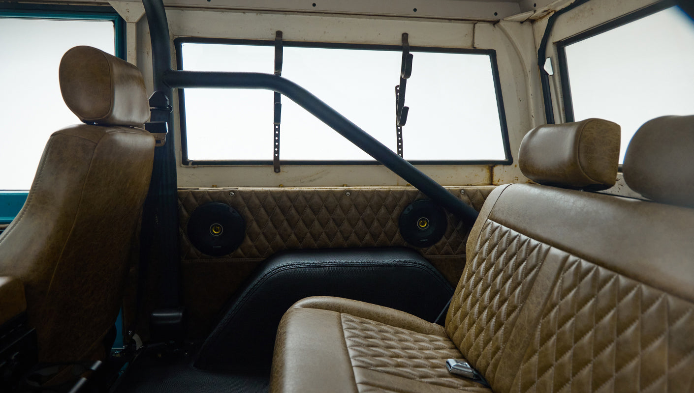 Classic Ford Bronco rear seats, roll cage, and side door interior with quilted leather