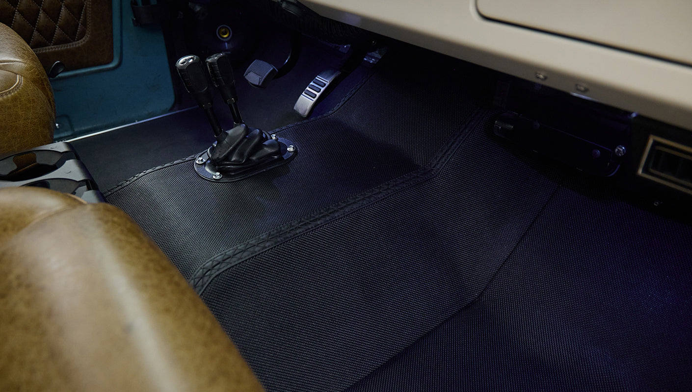 Leather seats with floor pedals and gear levers inside Classic Ford Bronco
