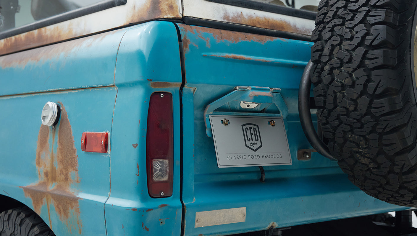 Rear corner of Classic Ford Bronco with turquoise patina and CFB Series license plate