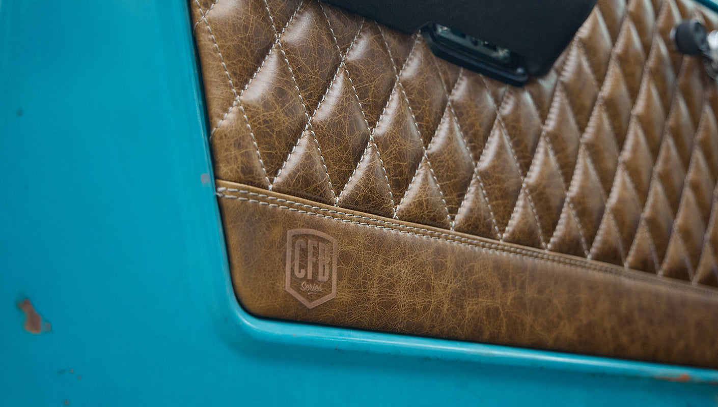 Close-up of tan diamond-stitched leather door panel with Classic Ford Bronco CFB Series logo