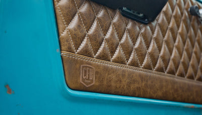 Close-up of tan diamond-stitched leather door panel with Classic Ford Bronco CFB Series logo