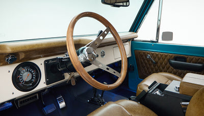 Steering wheel and tan leather front seats inside Classic Ford Bronco