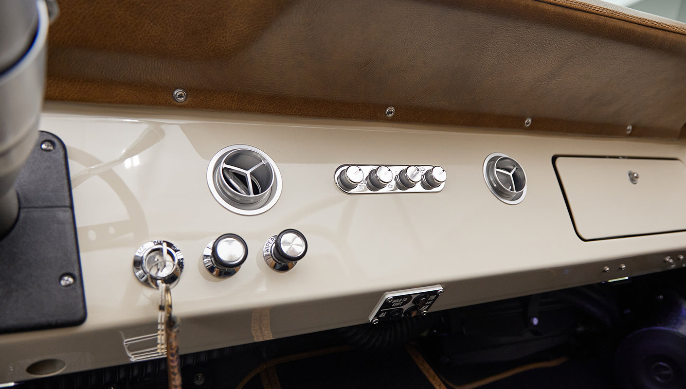 Dashboard of Classic Ford Bronco with chrome knobs and air vents