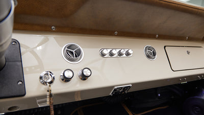 Dashboard of Classic Ford Bronco with chrome knobs and air vents