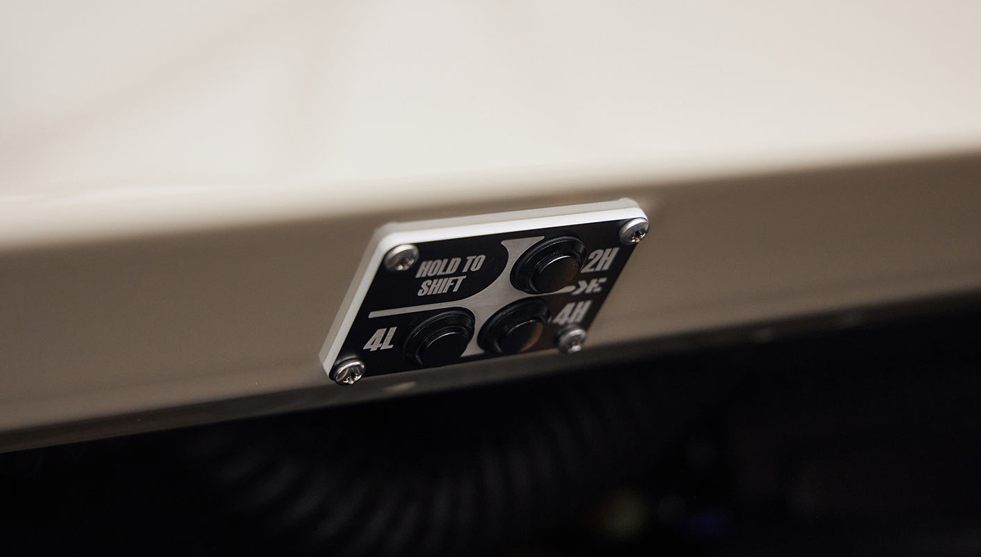 Control panel with buttons for 4L, 2H, and 4H drive modes on a Classic Ford Bronco dashboard