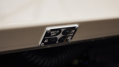 Control panel with buttons for 4L, 2H, and 4H drive modes on a Classic Ford Bronco dashboard