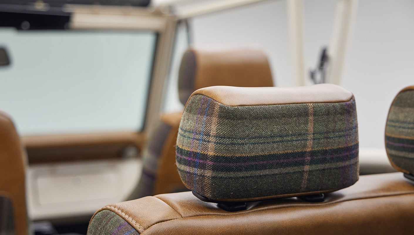 Headrest with plaid upholstery detail inside Classic Ford Bronco
