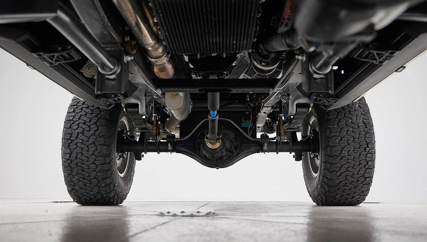 Lower underside view of Classic Ford Bronco with leaf spring suspension and off-road tires