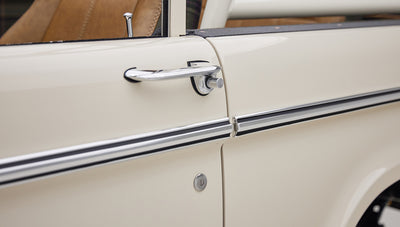 Close-up of a Classic Ford Bronco door handle and side molding in cream color