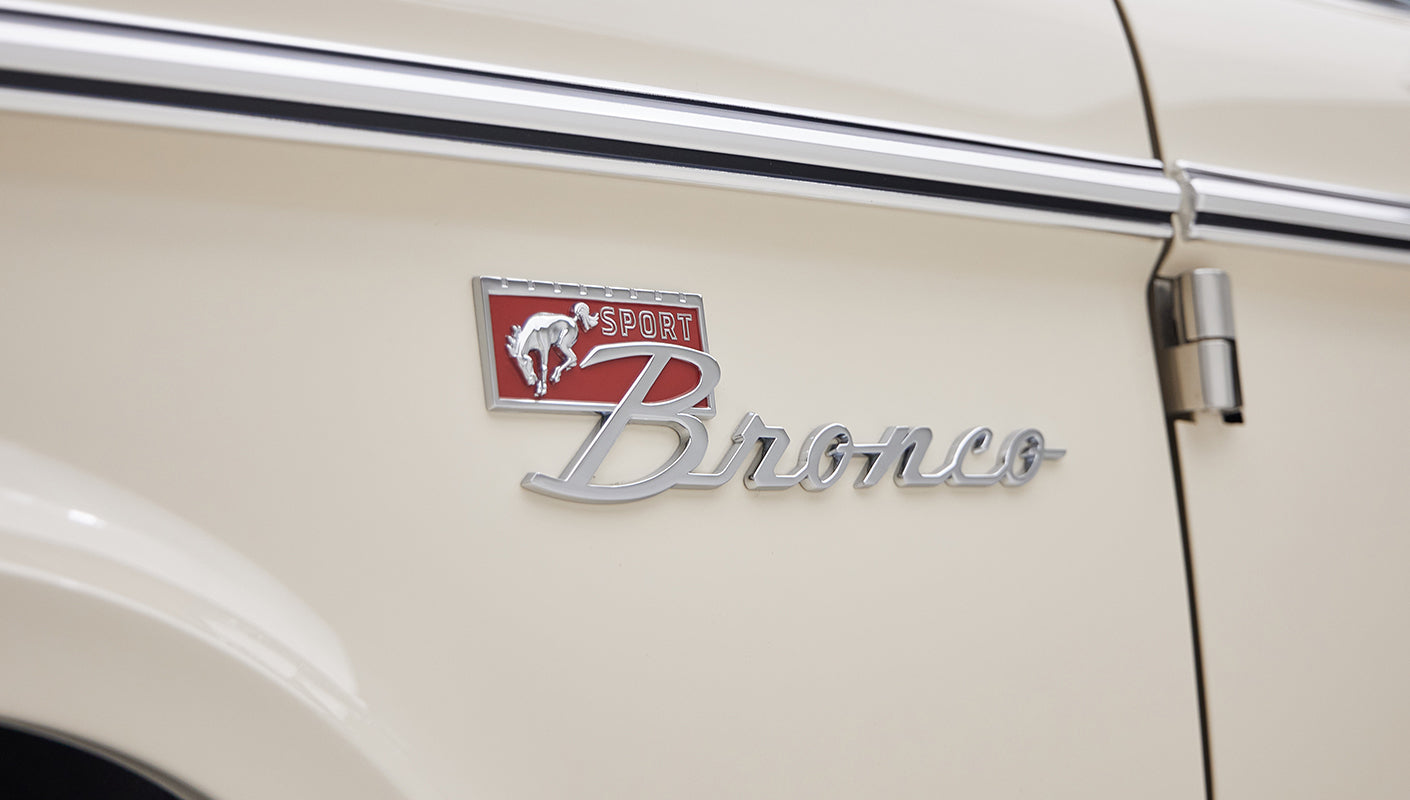 Close-up of Classic Ford Bronco side emblem reading 'Sport Bronco' with a bucking horse