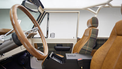 Side view of Classic Ford Bronco interior showing driver and passenger seats and steering wheel