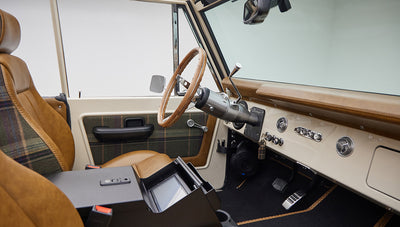 Driver side interior of Classic Ford Bronco with steering wheel and dashboard visible