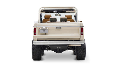 Classic Ford Bronco cream color rear view showing tailgate, bumper, and tires on white background