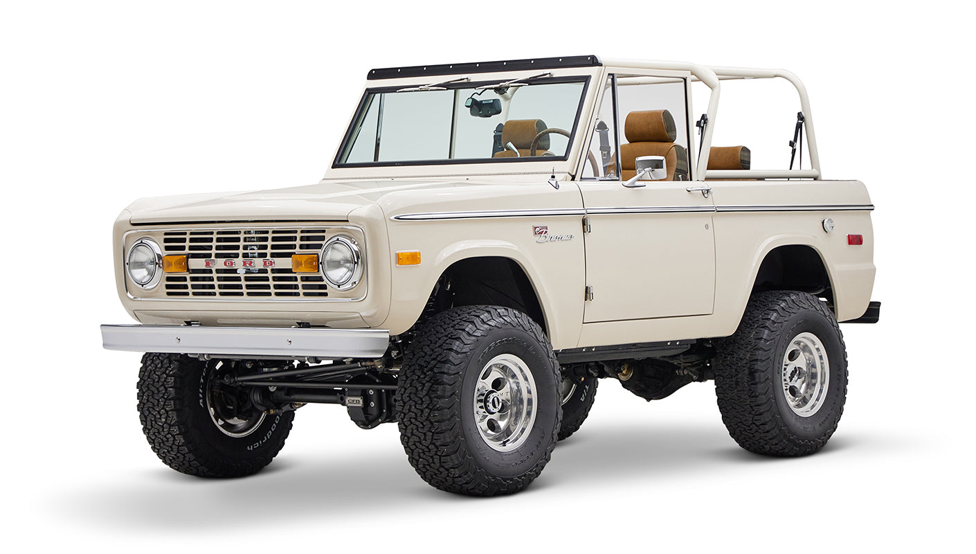 Classic Ford Bronco cream color with brown interior visible from front-right angle on white background