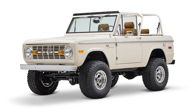 Classic Ford Bronco cream color with brown interior visible from front-right angle on white background