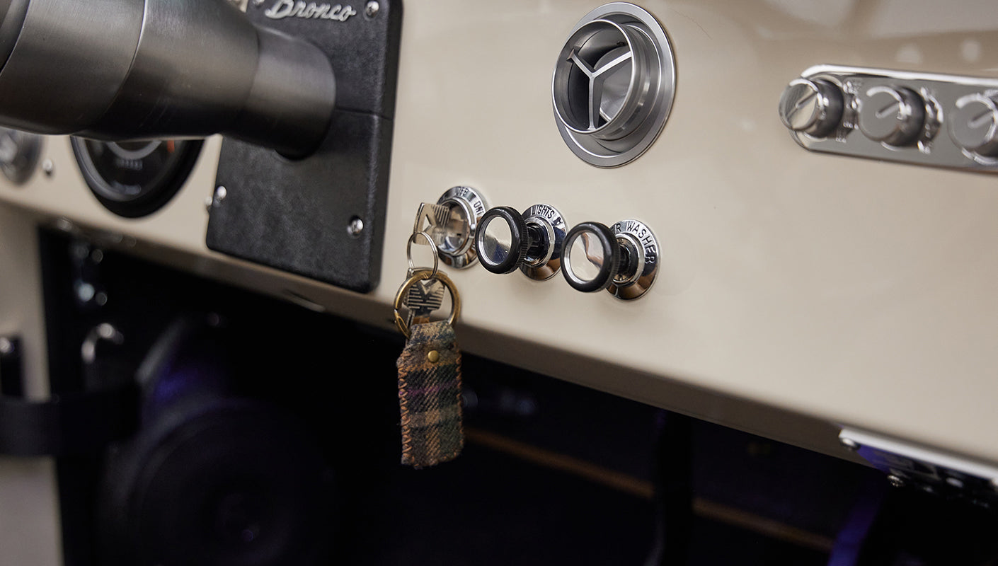 Close-up view of ignition key and dashboard knobs in a Classic Ford Bronco