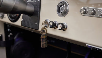 Close-up view of ignition key and dashboard knobs in a Classic Ford Bronco