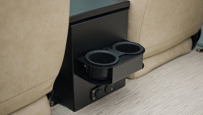 Black double cup holder mounted on black center console between beige seats in Classic Ford Bronco