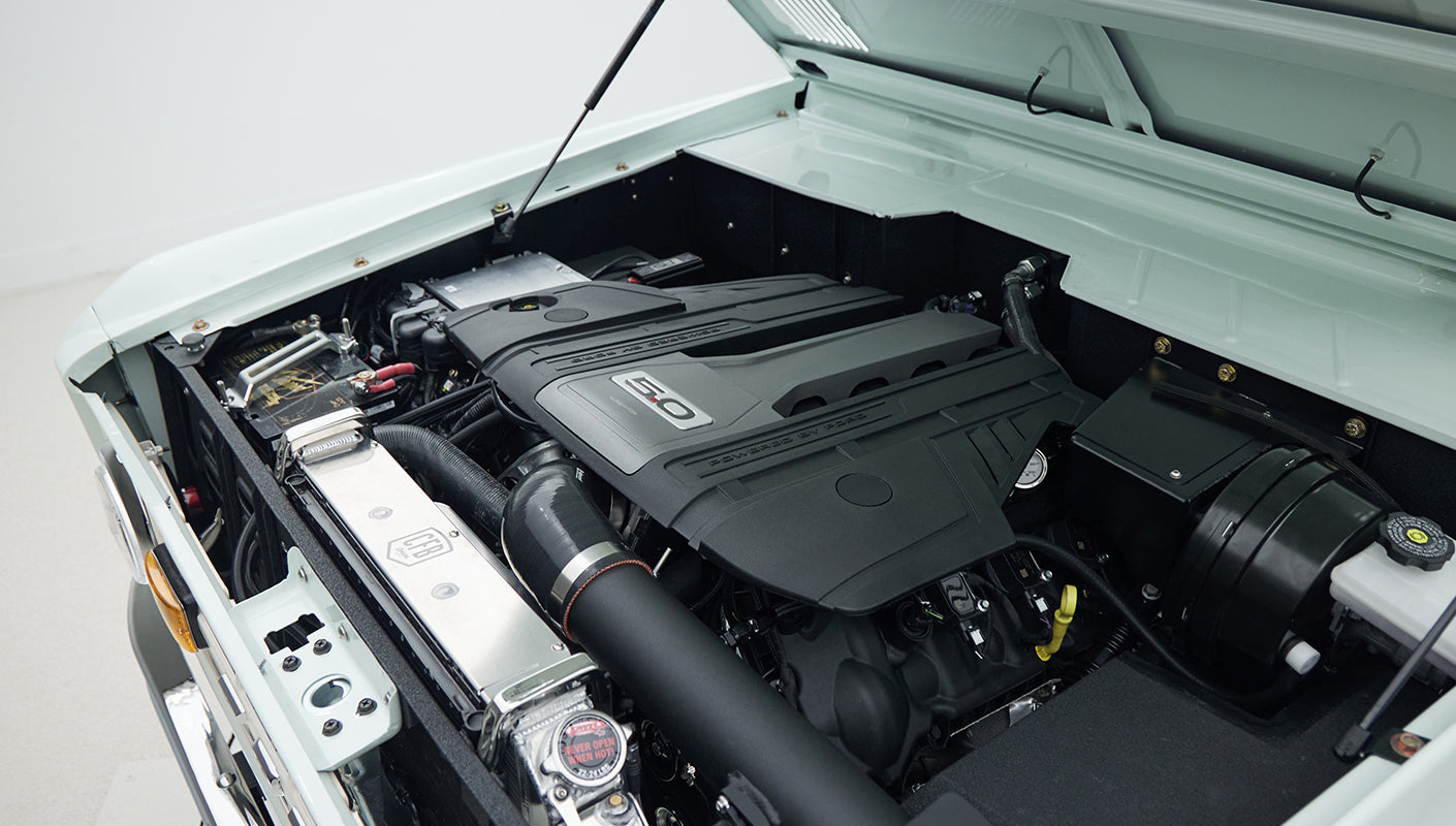 Classic Ford Bronco engine bay showing detailed engine components and air intake system