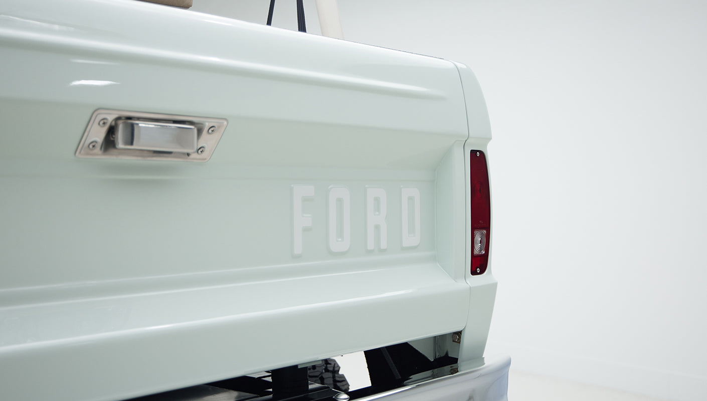 Rear tailgate of Classic Ford Bronco with large raised FORD lettering and side light