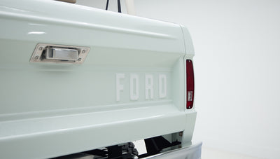 Rear tailgate of Classic Ford Bronco with large raised FORD lettering and side light