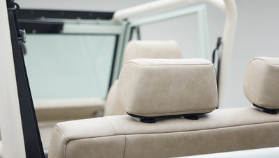 Beige leather upholstery with headrest visible from rear seats inside Classic Ford Bronco
