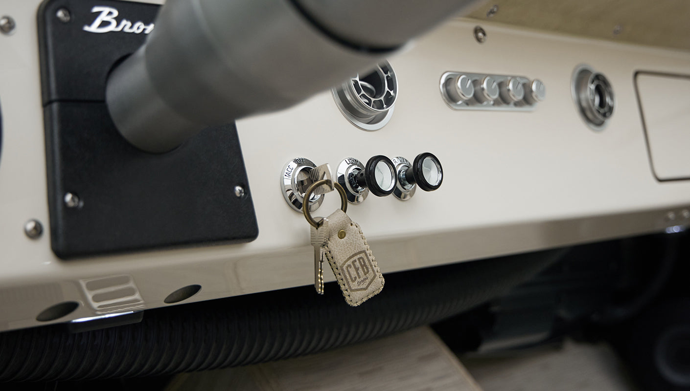 Close-up of Classic Ford Bronco dashboard switches and ignition with CFB Series keychain