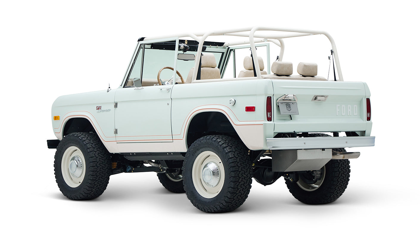Rear three-quarter view of white Classic Ford Bronco 1974 Diamondblue Coyote Series with open back