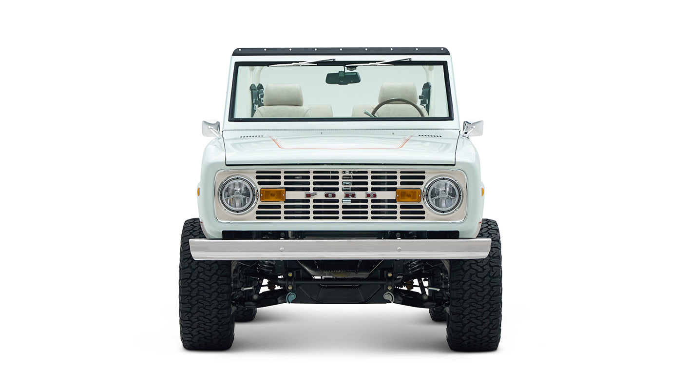 Front view of white Classic Ford Bronco 1974 Diamondblue Coyote Series with classic grille and bumper